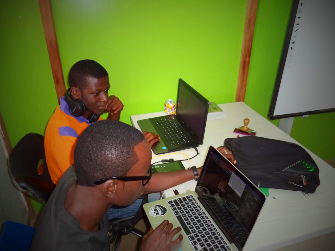 photo 1540058404349 2e5fabf32d75.jpg Two Nigerian startup founders working on laptops at Nhub Nigeria tech hub, deciding between SEO and Google Ads
