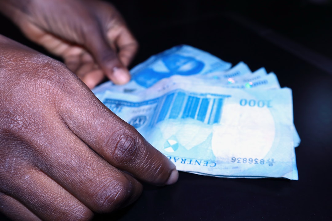 Nigerian naira banknotes held in hand, representing digital marketing costs and pricing in Nigeria